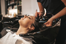 Beautiful Young Woman Getting A Hair Wash. Hair Salon Styling Concept.