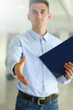 © kuprevich - Handsome man holding paper tablet
