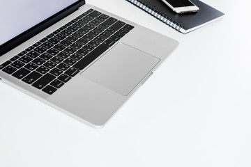 Poster - Side view of modern technology that works on a white desk and free space for text messages with a white laptop computer. And accessories on the table
