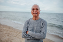 Asian Senior Old Man Practice Tai Chi And Yoga Pose On The Beach Sunrise