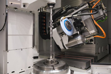 Poster - metalworking industry. drilling a hole on modern metal working machining center