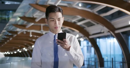 man use phone while walking