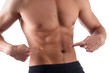 © khmelev - Athlete with a strong torso shows fingers on the cubes on his stomach. Muscular man shows his abs, isolated on white background