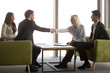 © fizkes - Diverse business partners handshake at casual meeting