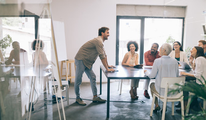 Cheerful coworkers in office during company meeting