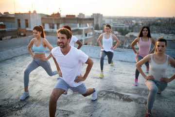 Sticker - Group of happy fit friends exercising outdoor in city