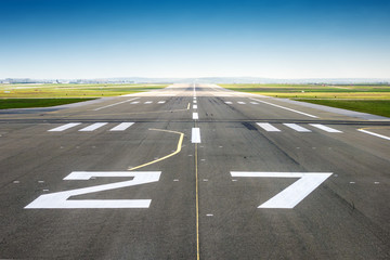 vanishing point of view from an airport track, blue sky background