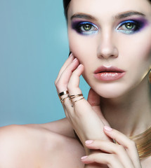 beautiful fashion model wearing elegant jewelry in color light