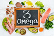 Foods containing omega 3. Vitamin Healthy foods: avocados, fish, shrimp, broccoli, flax, nuts, eggs, parsley. Top view. Free space for your text. On a white wooden background.