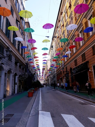 Genova, Italy - 06/01/2019: Bright abstract background of jumble of rainbow colored umbrellas over the city celebrating gay pride © yohananegusse