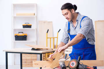 Young male carpenter working indoors 