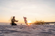 © Westend61 - Germany, Bavaria, Herrsching, father and daughter playing on the beach at sunset