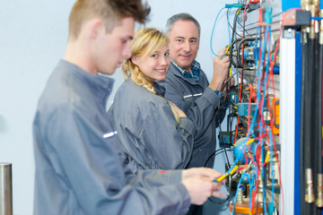 electrical technical team staring at colleague