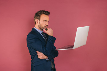 Wall Mural - Handsome businessman working in a laptop