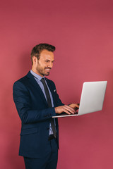 Wall Mural - Handsome businessman working in a laptop