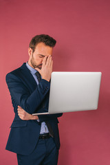 Wall Mural - Handsome businessman working in a laptop