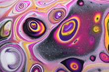 Closeup On A Retro Abstract Acrylic Pour Painting That Is Done In Golden Yellow, Black, Magenta, White, And Dark Violet.