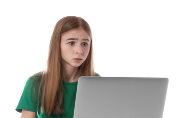 Wall Mural - Shocked teenage girl with laptop on white background. Danger of internet