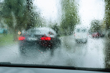 Wall Mural - Blurred view of road through wet car window. Rainy weather