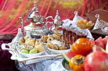Oriental Tea Tray And Cookies Symbolising Moroccan Hospitality, Islamic Holidays Food With Decoration. Ramadan Kareem. Eid Mubarak. Oriental Hospitality Concept. Tea Glasses And Pot, Traditional Delig