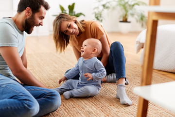 Wall Mural - Parents Sitting On Floor At Home Playing With Baby Son