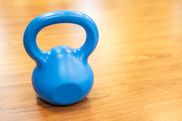 Wall Mural - blue kettlebell in a gym.