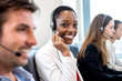 African American woman working in call center office with diverse team