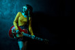 © Screaghin - Sensual young hipster woman with curly hair with red guitar in neon lights. Rock musician is playing electrical guitar. 90s style concept.