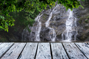 Wall Mural - Wooden table in green forest and Waterfall background,For product display. Beautiful.