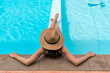 © aFotostock - Back side of young beauty woman lay down in swimming pool wear hat. Summer Fashion style concept.