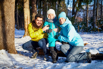 Happy family walking in a winter forest