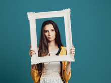 Beautiful Woman Posing And Holding A Frame
