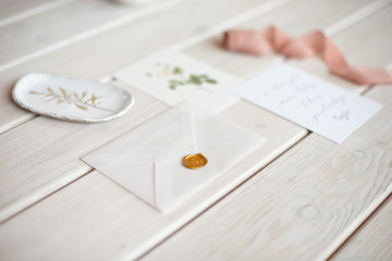 Feminine wedding desktop mock-up with blank paper card and Eucalyptus populus branch on white shabby table background. Empty space. Styled stock photo, web banner. Flat lay, top view