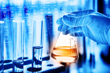 Wall Mural - flask in scientist hand with lab glassware background in laboratory. science or chemical research an