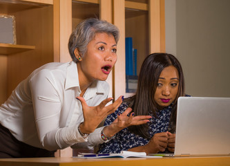 upset business woman nagging and scolding on employee girl angry for computer mistake in office boss or chief authority and assistant suffering reprimand