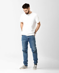 Wall Mural - Stylish young man in jeans on white background