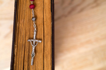 Wall Mural - Cross on the Bible on a wooden background. Holy book.