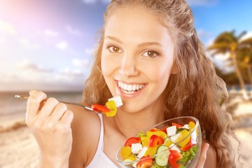 Poster - Attractive caucasian smiling woman with salad  isolated