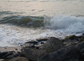 Southern tropical summer evening ocean coast at sunset. Restless sea and waves.