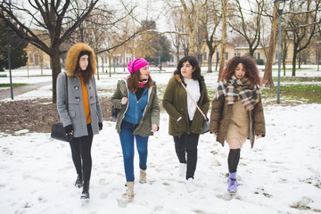 group of young women walking outdoor in winter day