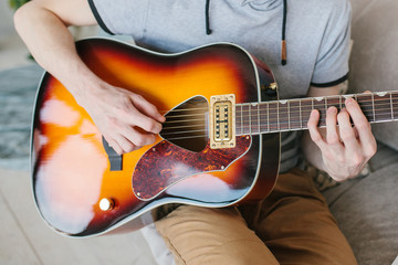 Wall Mural - Learning to play the guitar. Extracurricular activities or tutoring or hobbies or creative activities.