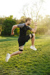 © Drobot Dean - Handsome young strong sports man posing outdoors at the nature park location make exercises with fitness equipment.