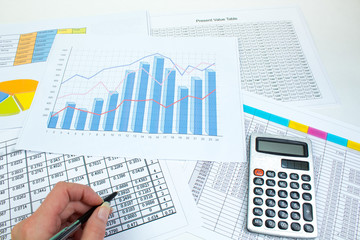 Financial printed paper charts, graphs and diagrams on the table. Top view