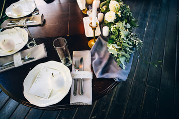 Wall Mural - Boho wedding table setting, rustic decorations, gold and blue details, wooden table, bokeh. Luxury wedding decor. Monstera leaves and orchid flowers.