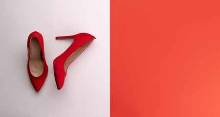 Wall Mural - A studio shot of pair of high heel shoes on color background. Flat lay.