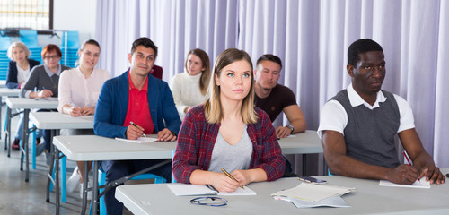 Adult students listening in classroom