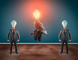 © allvision - Group of business man with lightbulbs instead of head. Lit lightbulb businessman jumping.