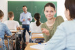 © JackF - Smiling schoolgirls are talking about homework at the desk in time lecture