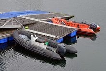 Inflatable Motor Boat Moored At A Wooden Piers