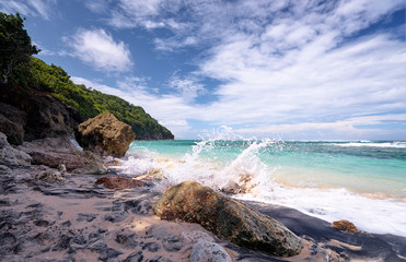 Beautiful seascape. Beach with white sand, rocks and blue cloudy sky.